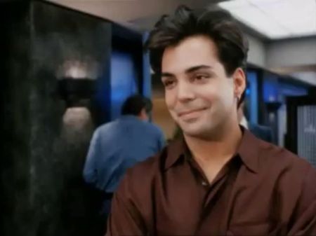 Richard Grieco in a brown shirt poses for a picture.